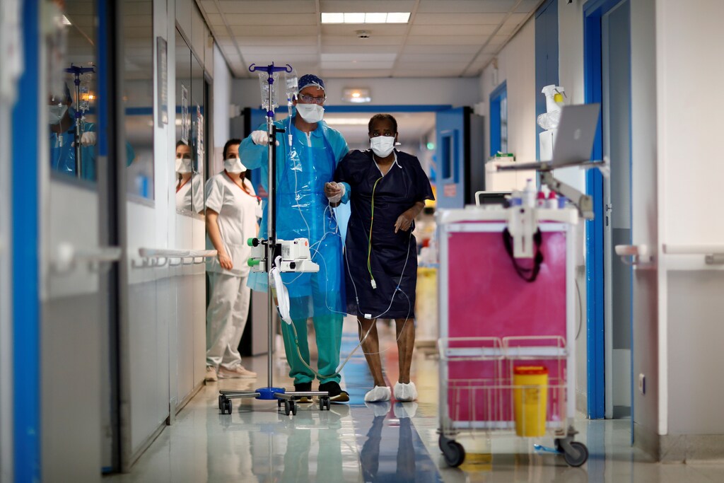 Patient Kouyate, 69-year-old, practices rehabilitation exercises with physiotherapist Christophe Passot after spending 21 days in the Intensive Care Unit (ICU) for coronavirus disease (COVID-19) patients at the Centre Cardiologique du Nord private hospital in Saint-Denis near Paris as the spread of the coronavirus disease continues in France, April 22, 2020. REUTERS/Gonzalo Fuentes - RC2P9G9CR8AG