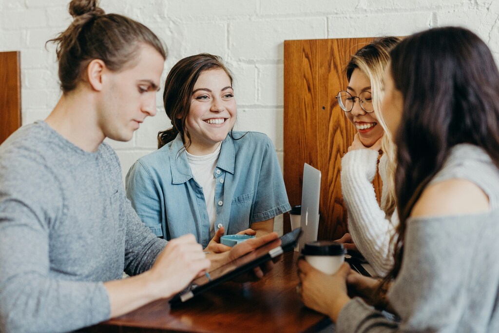 Side view of several people in a meeting in a blog post about effective leadership