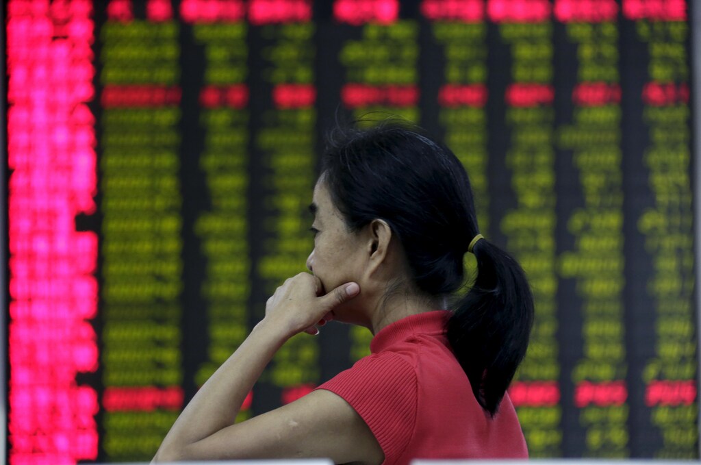 An investor looks at an electronic board showing stock information at a brokerage house in Beijing, August 26, 2015. Asian shares struggled on Wednesday as investors feared fresh rate cuts in China would not be enough to stabilise its slowing economy or halt a stock collapse that is wreaking havoc in global markets. REUTERS/Jason Lee - GF10000182914
