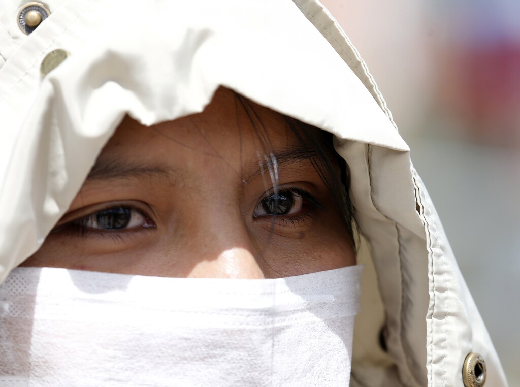 Mariluna Apaza, a stranded Peruvian passenger, talks with Reuters at the border line between Peru and Bolivia after Peru's government's announcement of border closure in a bid to slow the spread of the new coronavirus (COVID-19), in Desaguadero, Bolivia, March 17, 2020. REUTERS/David Mercado - RC2YLF9Z12TR
