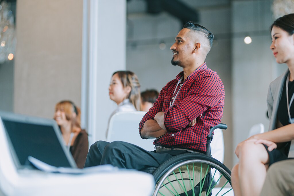 Asian Indian Disable man in wheelchair listening to presenter's speech in a blog about disability data