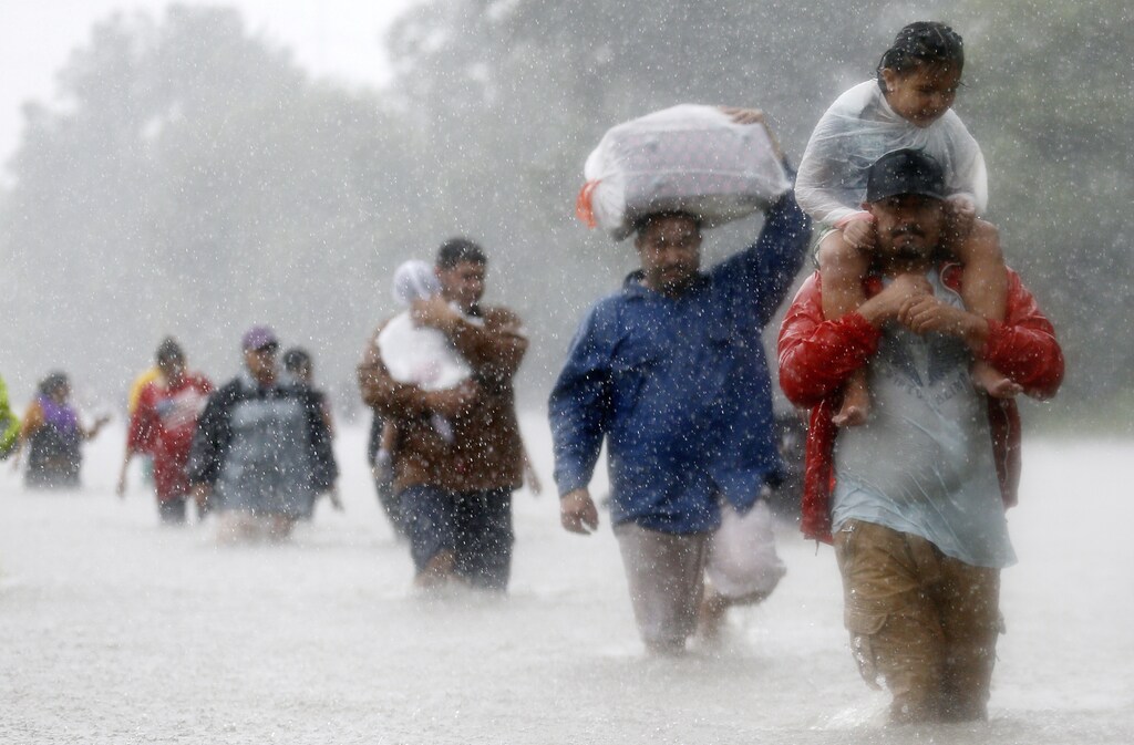 Residents wade through flood waters from Tropical Storm Harvey in Beaumont Place, Houston, Texas, U.S., on August 28, 2017. REUTERS/Jonathan Bachman - RTX3DQKG