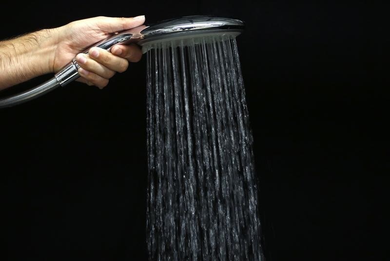 An engineer demonstrates a shower head at the spray laboratory of bathroom and sanitation company Hansgrohe, in Schiltach, in the Black Forest, Southwestern Germany, November 3, 2014.