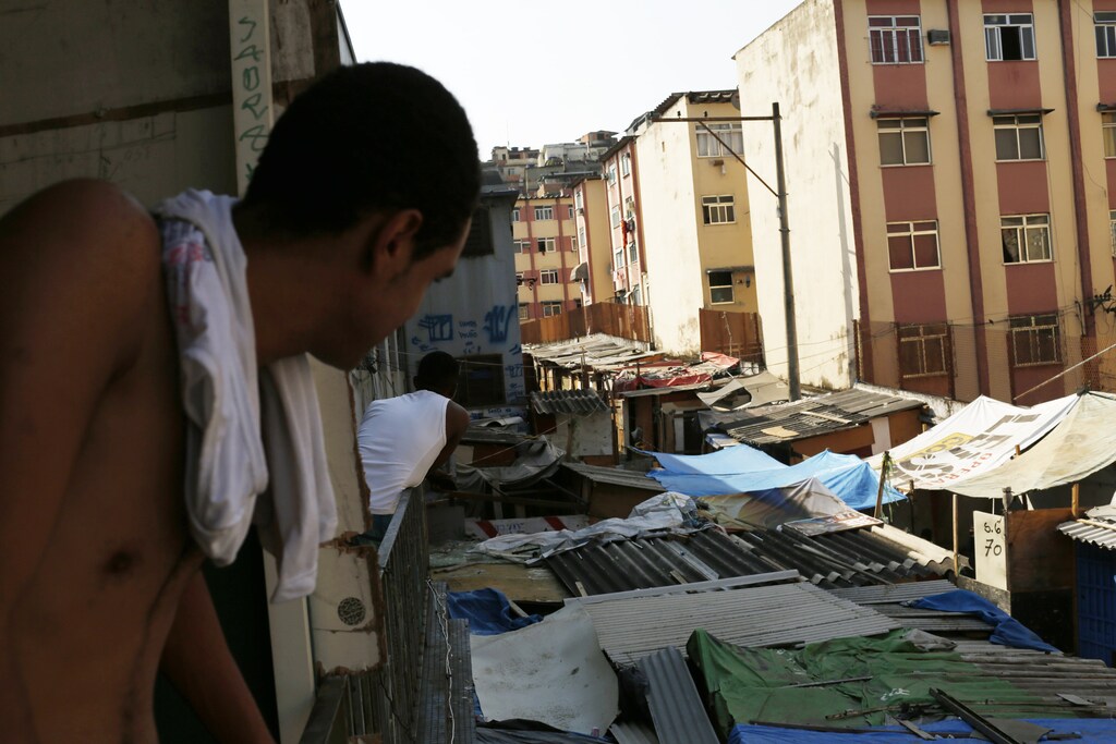Makeshift homes, part of the Nova Tuffy slum, are pictured in an abandoned factory in Rio de Janeiro October 17, 2014. Since seven months ago, 1,800 families have been living inside the factory, which they occupied in March, with poor sanitation services and the fear of eviction. The occupants of the factory say they are not included in the housing program "Minha Casa, Minha Vida" (My House, My Life), and they would like to be included by the Brazilian government. The housing program is one of several government initiatives aimed at reducing poverty and social inequality that President Dilma Rousseff has held up as achievements of her administration as she campaigns for re-election. REUTERS/Pilar Olivares (BRAZIL - Tags: POLITICS SOCIETY POVERTY REAL ESTATE BUSINESS) - RTR4AMHH