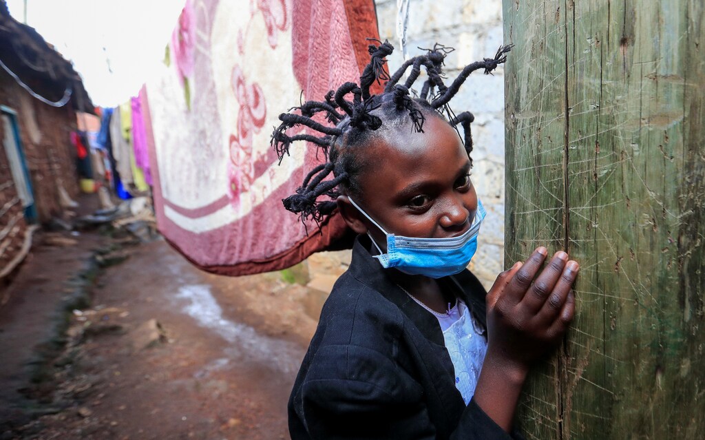 Martha Apisa, 12, poses for a photograph outside their house after plaiting with the "coronavirus" hairstyle, designed to emulate the prickly appearance of the virus under a microscope, as a fashion statement against the spread of the coronavirus disease (COVID-19), at Mama Brayo Beauty Salon within Kambi-Muru village of Kibera slums in Nairobi, Kenya April 29, 2020. Picture taken April 29, 2020. REUTERS/Thomas Mukoya - RC2YEG99VQE8