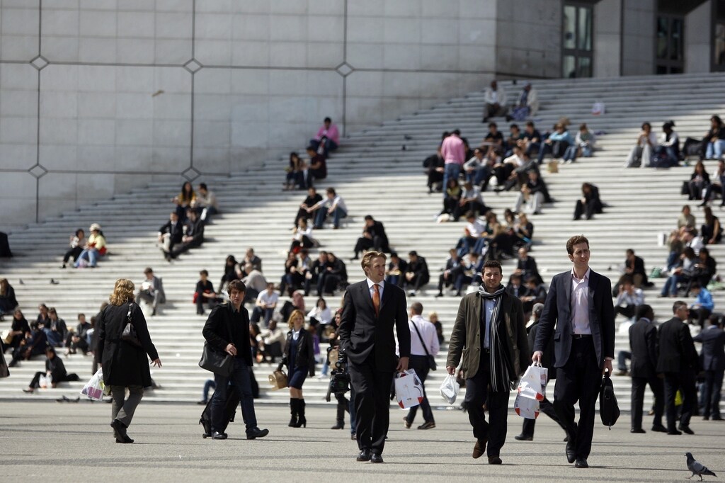 Businessmen and visitors enjoy the good weather on the stairs under the Arche de la Defense in the financial district of la Defense near Paris April 30, 2009.