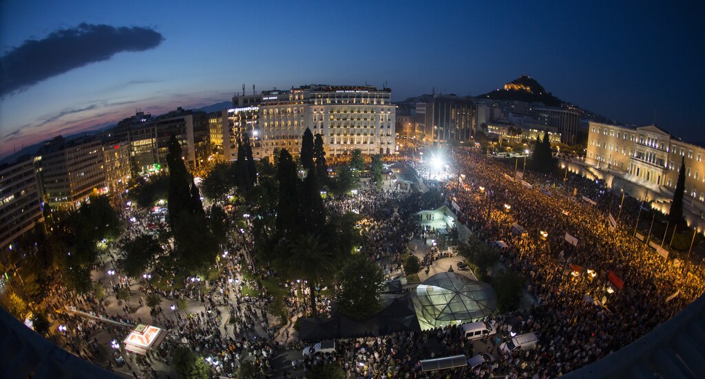Protesters attend an anti-austerity rally in front of the parliament building in Athens, Greece, June 29, 2015. Stunned Greeks faced shuttered banks, long supermarkets lines and overwhelming uncertainty on Monday as a breakdown in talks between Athens and its international creditors plunged the country deep into crisis. Picture taken with a fisheye lens. REUTERS/Marko Djurica