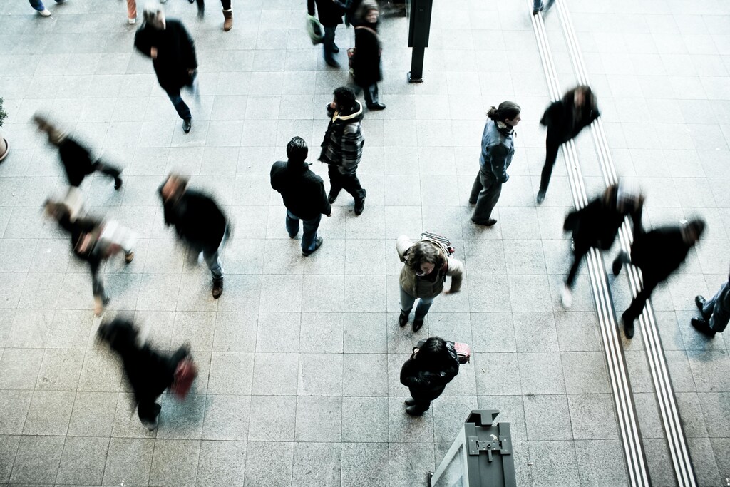 a busy environment with lots of people turning different ways