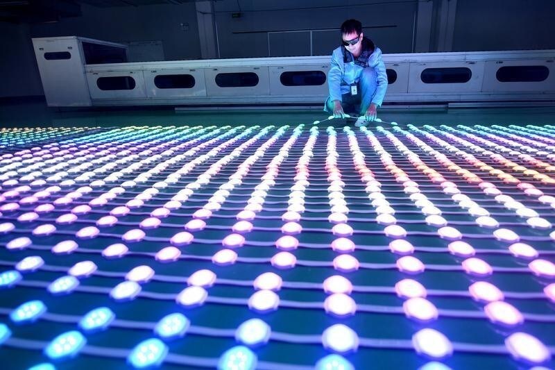 A staff member examines LED light bulbs at a company manufacturing lighting products in Haian, Jiangsu province, China November 15, 2018. REUTERS/Stringer ATTENTION EDITORS - THIS IMAGE WAS PROVIDED BY A THIRD PARTY. CHINA OUT. - RC1FF45A0DE0