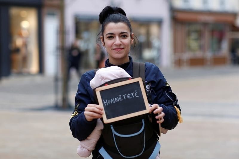 Cathy Dos Santos, 21, unemployed, holds a blackboard with the word "honnetete" (honesty), the most important election issue for her, as she poses for Reuters in Chartres, France February 1, 2017. She said: "Being honest means voting according to your own feelings and not letting others tell you what you should do." REUTERS/Stephane Mahe SEARCH "ELECTION CHARTRES" FOR THIS STORY. SEARCH "THE WIDER IMAGE" FOR ALL STORIES - RC181A924530