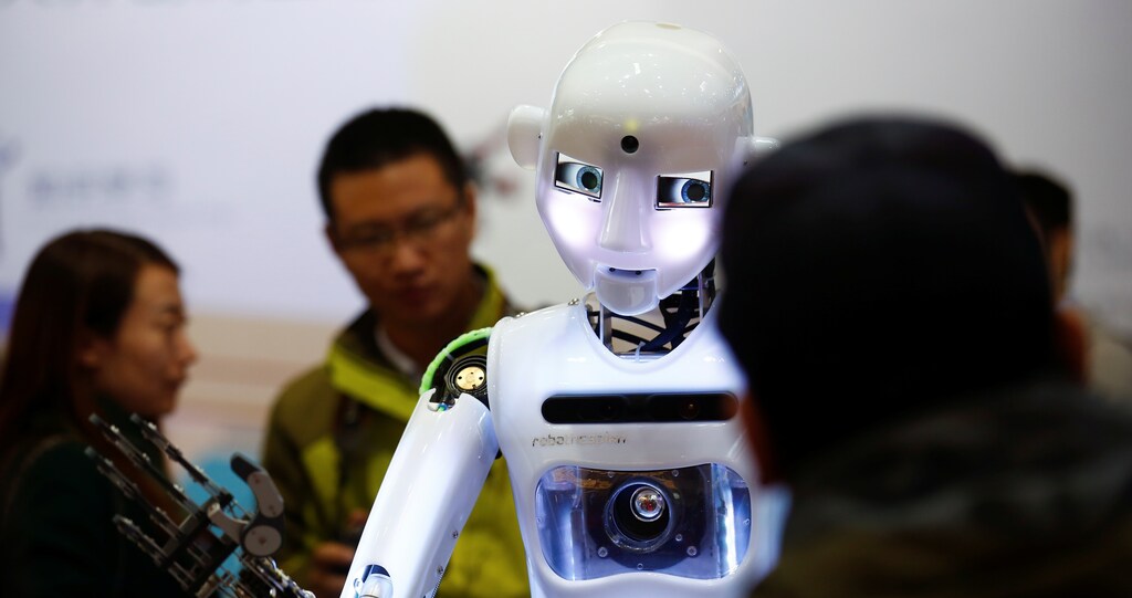 People look at a RoboThespian humanoid robot at the Tami Intelligence Technology stall at the WRC 2016 World Robot Conference in Beijing, China, October 21, 2016.
