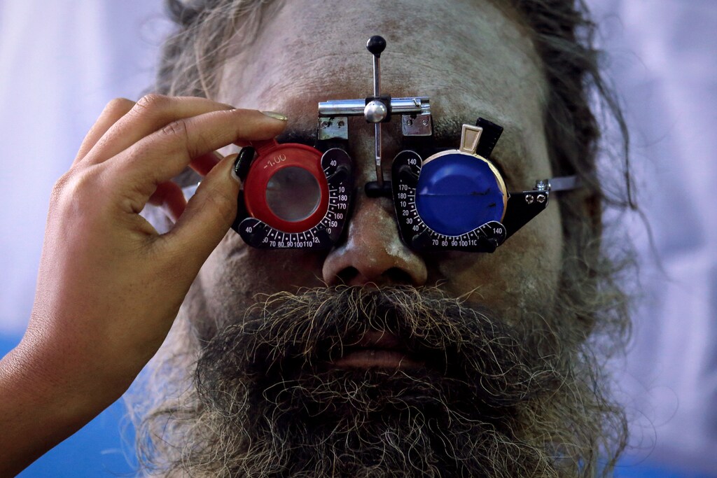 A Sadhu or a Hindu holy man gets his eyes tested at a free eye-care camp at a makeshift shelter before heading for an annual trip to Sagar Island for the one-day festival of "Makar Sankranti", in Kolkata, India, January 10, 2019