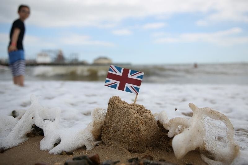 A sand castle is washed away by the sea in Clacton-on-Sea, a town in eastern England, where 70 percent of people voted on June 23, 2016 to leave the European Union, Britain August 22, 2016. REUTERS/Neil Hall