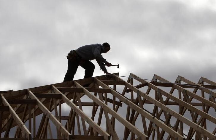 A tradesman uses a hammer on the framework of a new house on the outskirts of Melbourne August 3, 2010. Approvals to build new homes slipped for a third straight month, reflecting the drag of past rate hikes and adding to the case for steady monetary policy in the near term. REUTERS/Mick Tsikas (AUSTRALIA - Tags: BUSINESS CONSTRUCTION)
