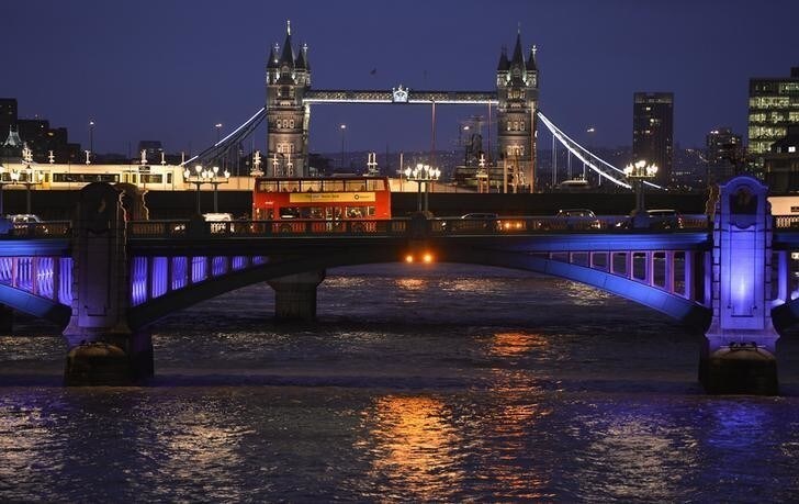 A London bus crosses the River Thames on London Bridge during the evening rush hour with Tower Bridge seen behind in London December 18, 2013. REUTERS/Toby Melville (BRITAIN - Tags: SOCIETY CITYSCAPE)