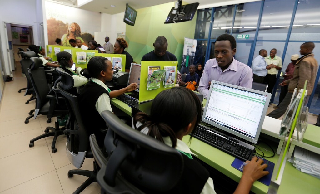 Employees serve customers inside a mobile phone care centre operated by Kenyan's telecom operator Safaricom in the central business district of Kenya's capital Nairobi, May 11, 2016.