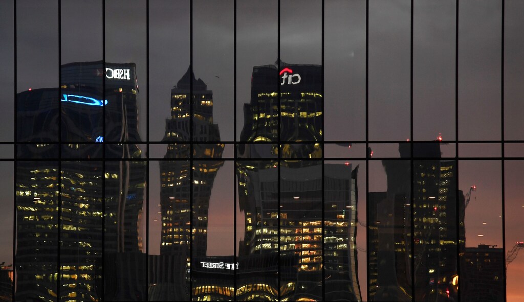 The Canary Wharf business district is seen reflected in windows at dusk in London, Britain December 11, 2016. REUTERS/Toby Melville - RC18A27440E0
