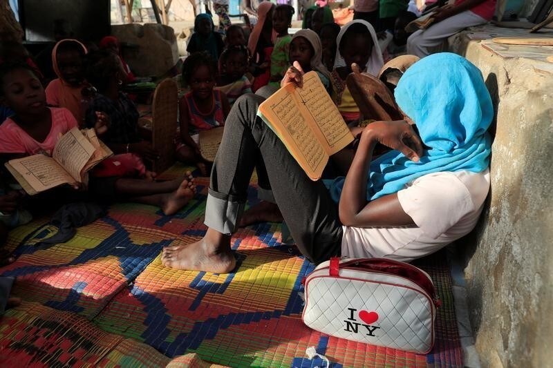 A girl learns to recite the Koran in a makeshift madrasa in Fass, a neighborhood of Dakar, Senegal November 5, 2018.