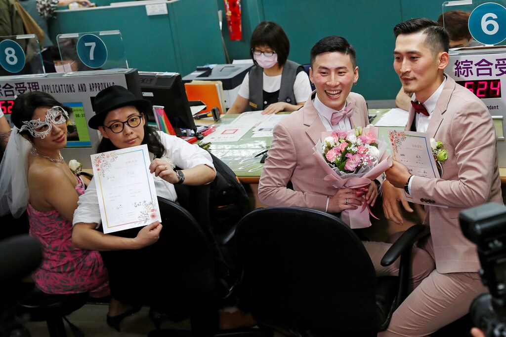 (L-R) Couples Li Ying-Chien and Cynical Chick, and Marc Yuan and Shane Lin, pose for photographs after registering for same-sex marriage at the Household Registration Office in Shinyi District in Taipei, Taiwan May 24, 2019. REUTERS/Tyrone Siu