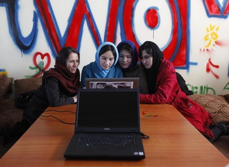 Afghan girls work at a first Internet cafe for women in Kabul March 8, 2012. Afghanistan opened its first female-only internet cafe on Thursday, hoping to give women a chance to connect to the world without verbal and sexual harassment and free from the unwanted gazes of their countrymen. REUTERS/Mohammad Ismail (AFGHANISTAN - Tags: SOCIETY) - GM1E83900H801