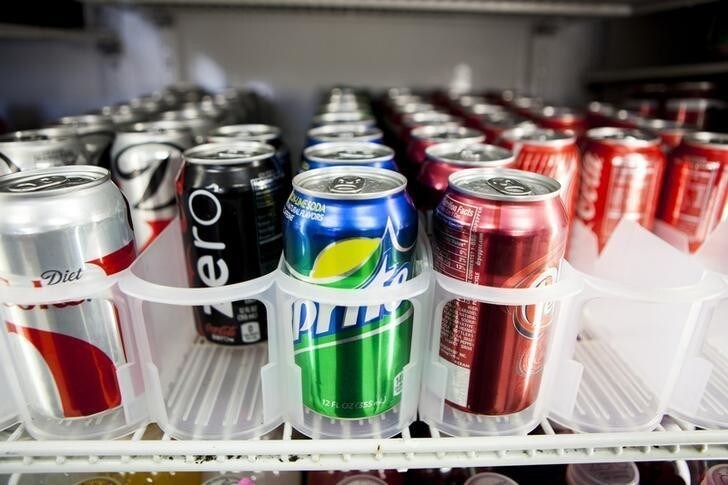 Cans of soda are displayed in a case at Kwik Stops Liquor in San Diego, California February 13, 2014. Sodas and most other sugar-sweetened drinks sold in California would be required to carry warning labels for obesity, diabetes and tooth decay under a bill introduced in Sacramento on Thursday and backed by several public health advocacy groups.