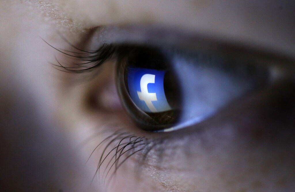 A picture illustration shows a Facebook logo reflected in a person's eye, in Zenica, March 13, 2015. Facebook Inc recorded a slight increase in government requests for account data in the second half of 2014, according to its Global Government Requests Report, which includes information about content removal.Requests for account data increased to 35,051 in the second half of 2014 from 34,946 in the first half, with requests from countries such as India rising and those from others including United States and Germany falling, the report by the world's largest Internet social network showed. Facebook said it restricted 9,707 pieces of content for violating local laws, 11 percent more than in the first half, with access restricted to 5,832 pieces in India and 3,624 in Turkey. Picture taken on March 13. REUTERS/Dado Ruvic (BOSNIA AND HERZEGOVINA - Tags: SOCIETY PORTRAIT SCIENCE TECHNOLOGY BUSINESS TELECOMS TPX IMAGES OF THE DAY) - GM1EB3H01I801