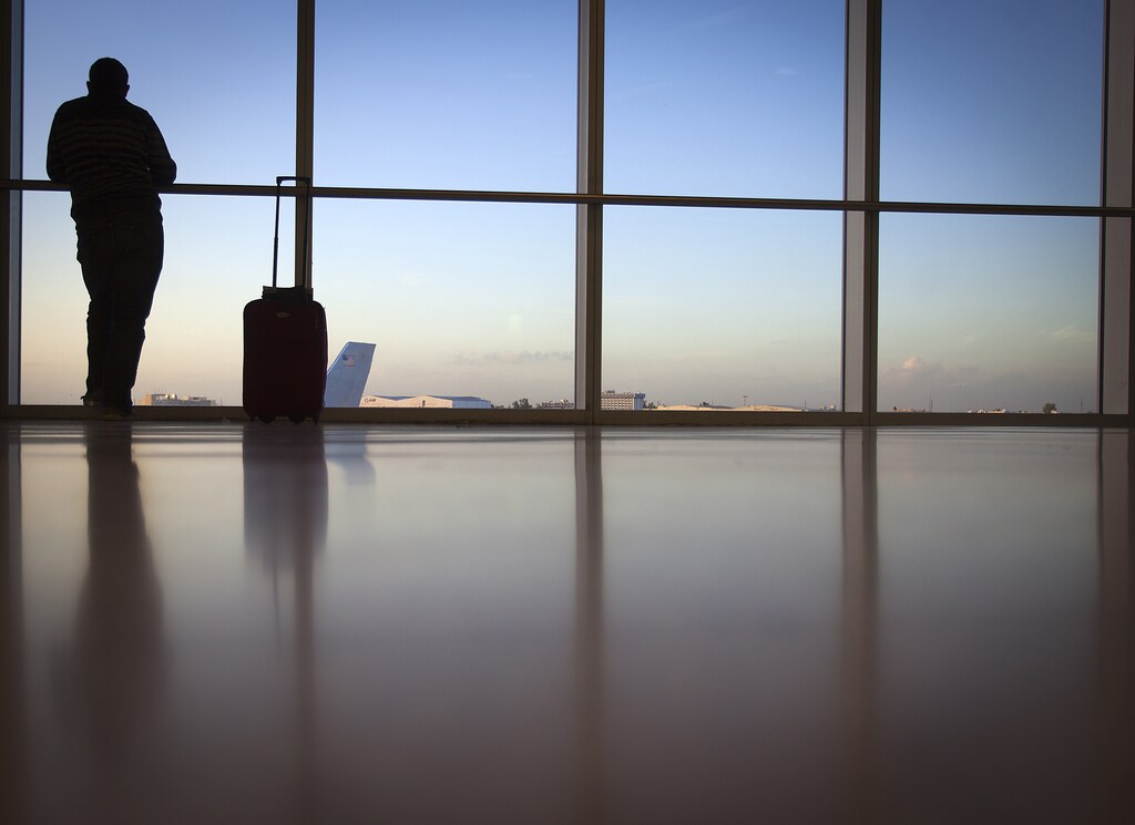 A passenger looks out the window at Miami International Airport in Miami December 10, 2013. Picture taken December 10, 2013. REUTERS/Carlo Allegri (UNITED STATES - Tags: TRANSPORT BUSINESS) - TM4E9CB00J301