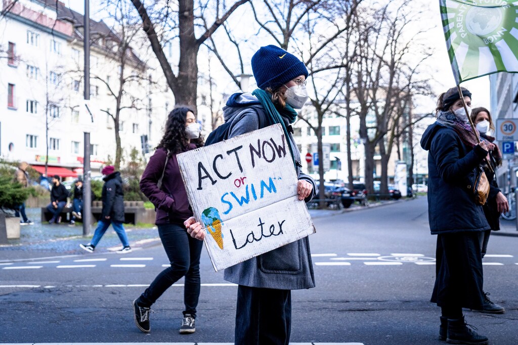 this sign saying 'act now or swim later' is an example of a nudge. It's providing people with information to steer them in the right direction and help fight climate change.