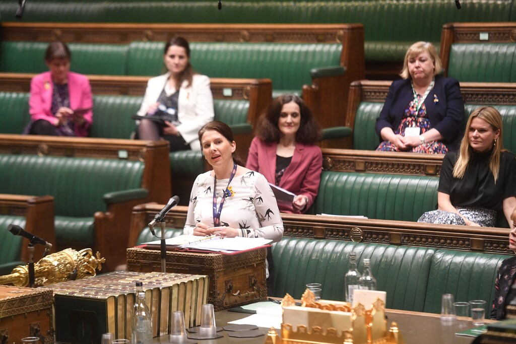 A group of female politicians in parliament.