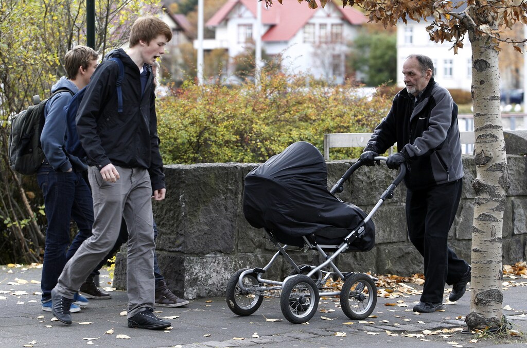 A man pushes a baby pram in a park in Reykjavik October 12, 2010. Nordic countries Iceland, Norway, Finland and Sweden continue to demonstrate the greatest equality between men and women according to the World Economic Forum's 2010 Global Gender Gap Report. REUTERS/Chris Helgren (ICELAND - Tags: SOCIETY) - RTXTD0U