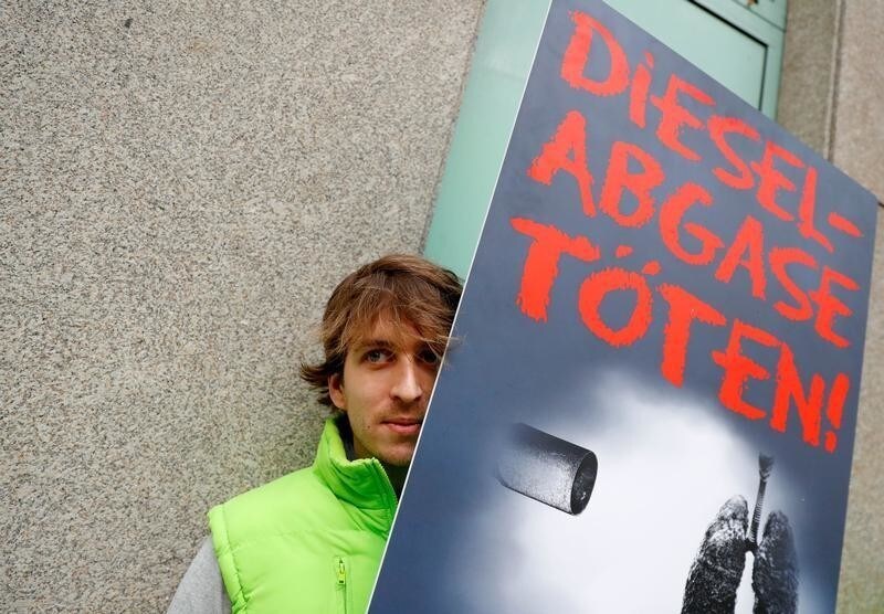 An environmental activist protests in front of a court before a court hearing on case seeking diesel cars ban in Berlin, Germany, October 9, 2018. The sign reads 'Diesel exhaust gases kill.'