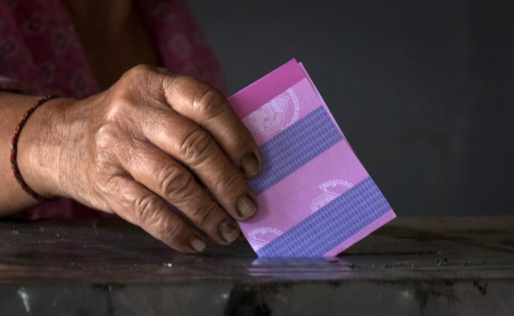 A woman places her vote into a ballot box at a rural polling station in the outskirts of Udon Thani north east Thailand on July 3, 2011. Thailand voted on Sunday in a general election that could trigger a new crisis after six years of turmoil. REUTERS/Adrees Latif (THAILAND - Tags: POLITICS ELECTIONS) - GM1E77319JL01