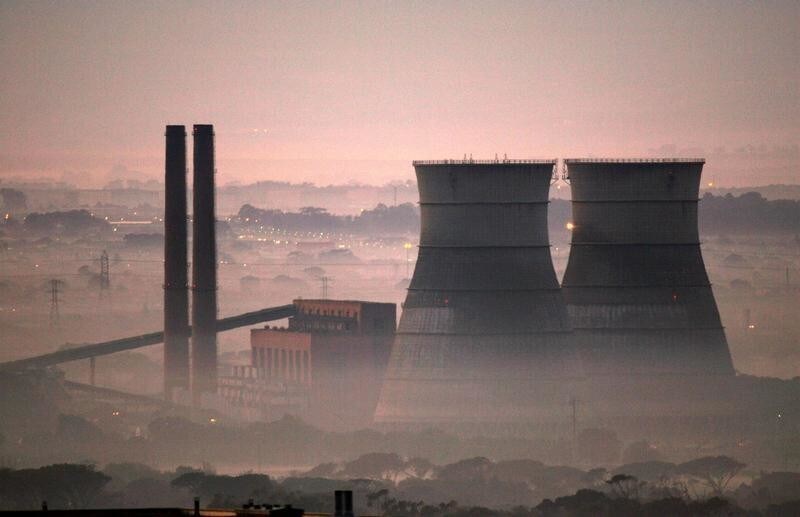 Early morning smog shrouds cooling towers of a power plant in Cape Town, South Africa, June 8, 2006.