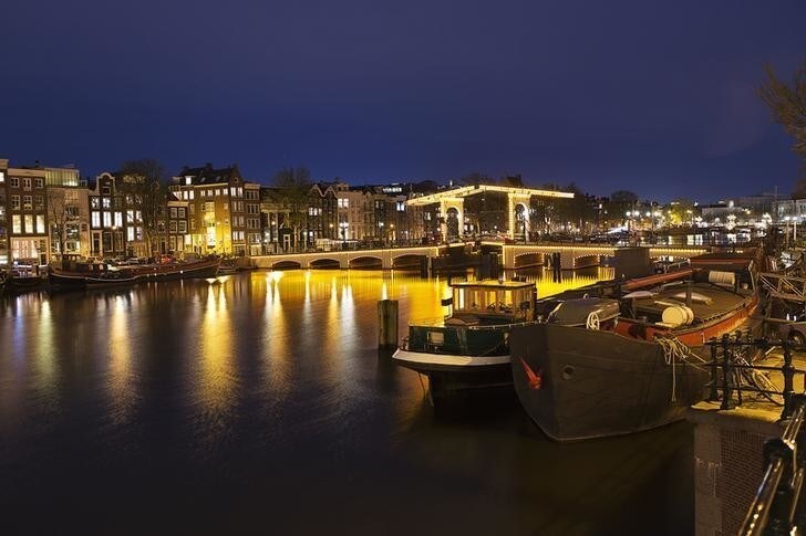 Nightview of the Magere Brug, the skinny bridge,the most famous bridge in Amsterdam April 22, 2013. The Royal celebrations in the Netherlands this week put the country and the capital Amsterdam on front pages and television screens around the world with an orange splash. There's plenty to see and do in 48 hours in this compact city, where the world-famous Rijksmuseum only recently reopened after an extensive renovation. Picture taken April 22, 2013. To match story TRAVEL-AMSTERDAM/ REUTERS/Michael Kooren (NETHERLANDS - Tags: TRAVEL)