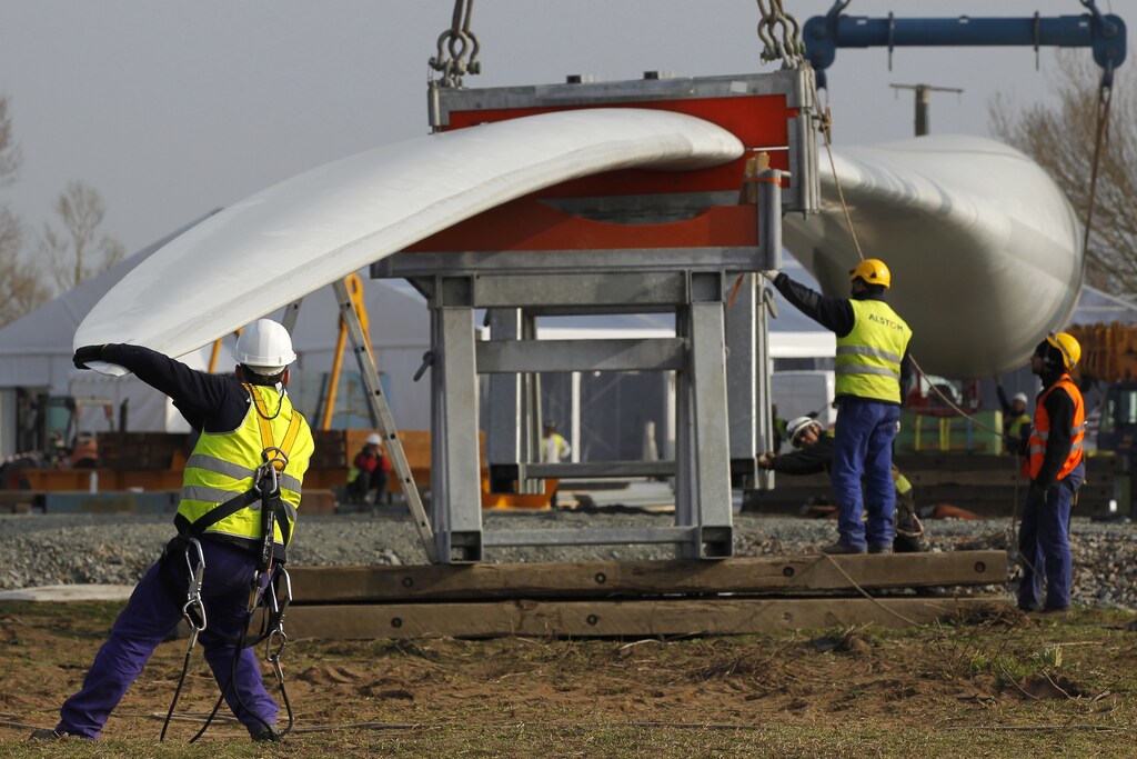 Technicians preparing the installation of a wind turbine blade.