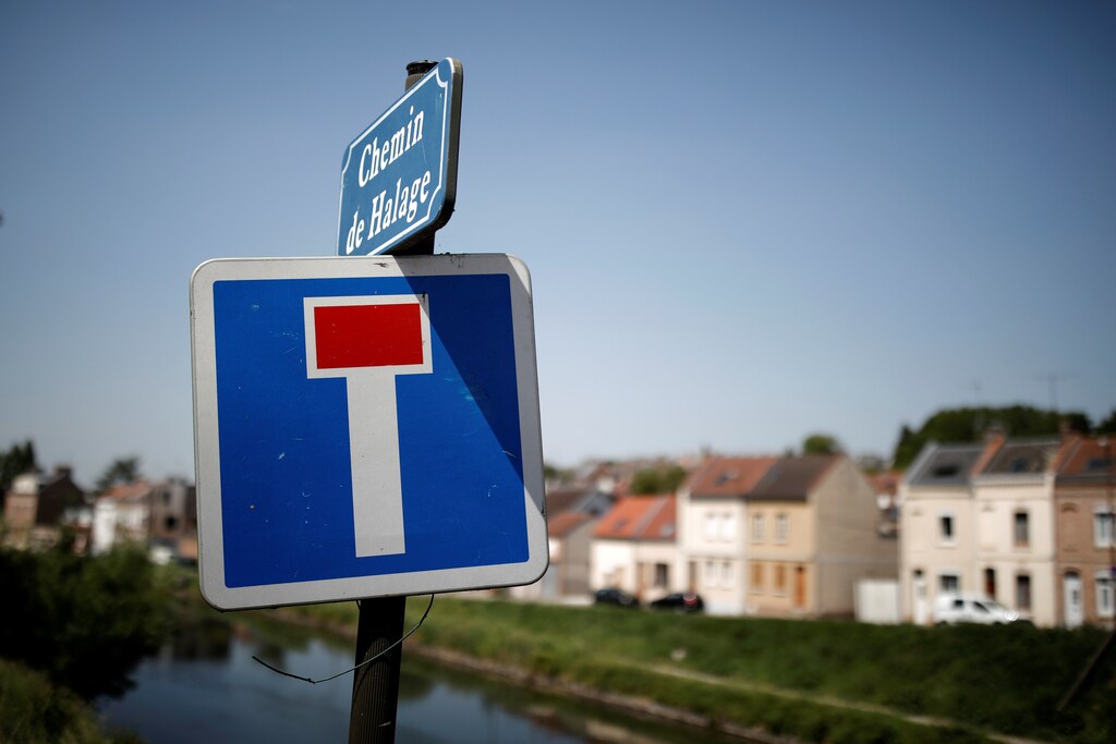A canal towpath with a dead end road sign is seen in the northern city of Amiens, France, June 14, 2017. Picture taken June 14, 2017. REUTERS/Benoit Tessier - RC1A6ECD5200