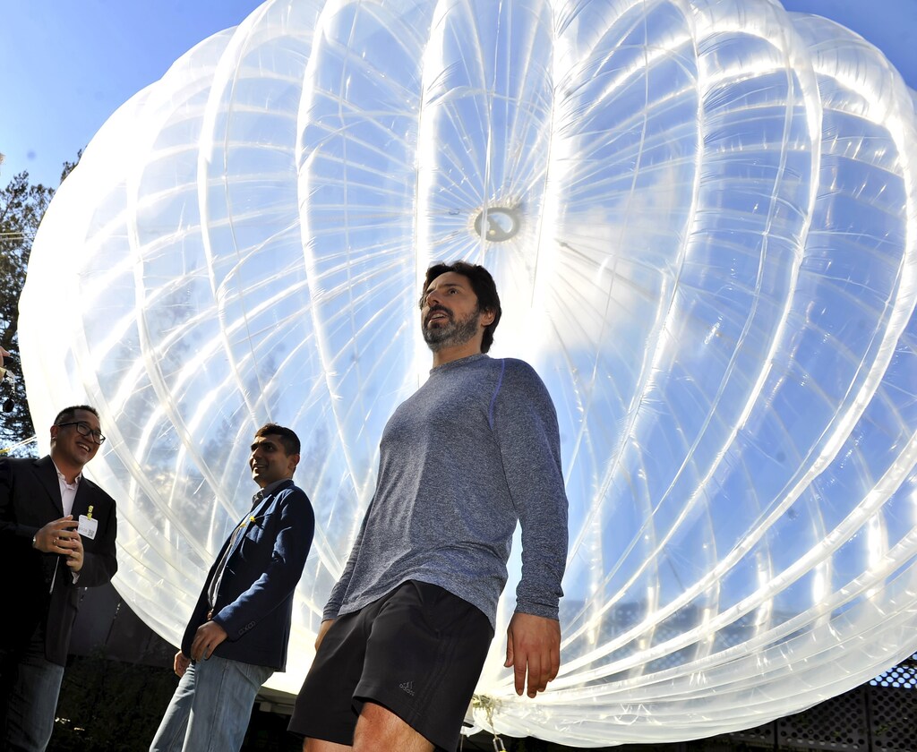 Google co-founder Sergey Brin (R) walks in front of a giant balloon to show "Project Loon" to Indonesian delegates at the Google office in Mountain View, California,