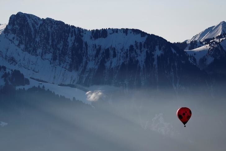 A balloon flies over Swiss mountains during the International Hot Air Balloon Week in Chateau-d'Oex, Switzerland January 27, 2018. REUTERS/Stefan Wermuth TPX IMAGES OF THE DAY
