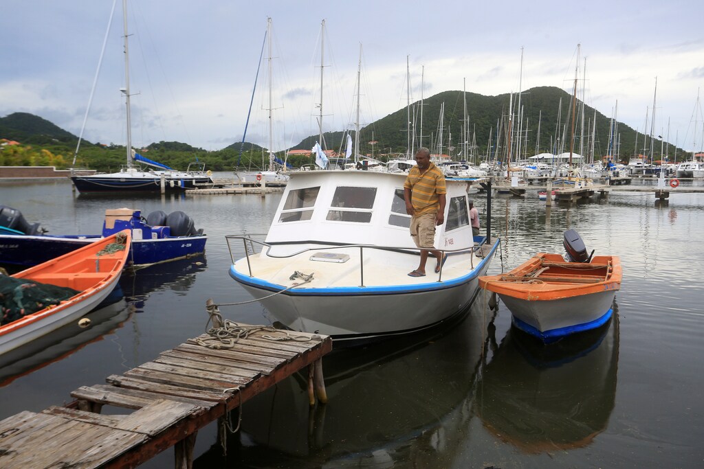 Fisherman Desmond Popo checks his boat in the aftermath of Tropical Storm Dorian at Rodney Bay in St. Lucia, August 27, 2019. REUTERS/Andrea de Silva - RC17A6CC1290