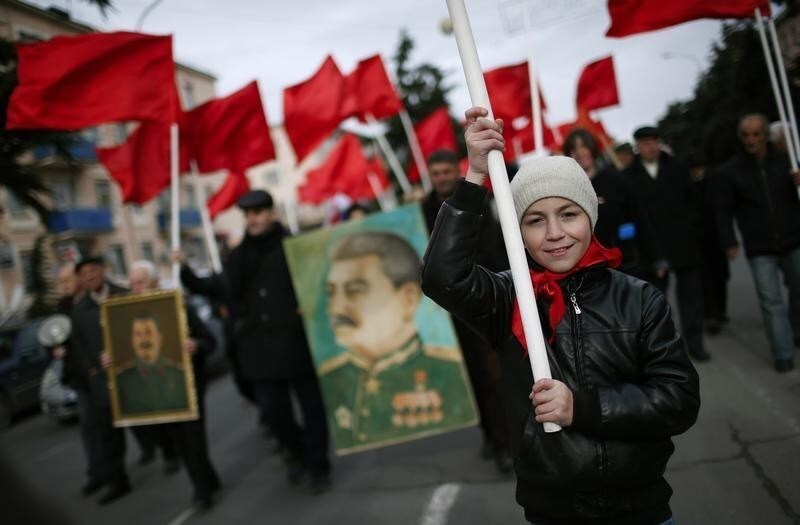 People carry flags and portraits of Soviet leader Joseph Stalin while marching during a rally to mark Stalin's birthday anniversary at his hometown in Gori, Georgia, December 21, 2015. REUTERS/David Mdzinarishvili - D1BESCPBESAA