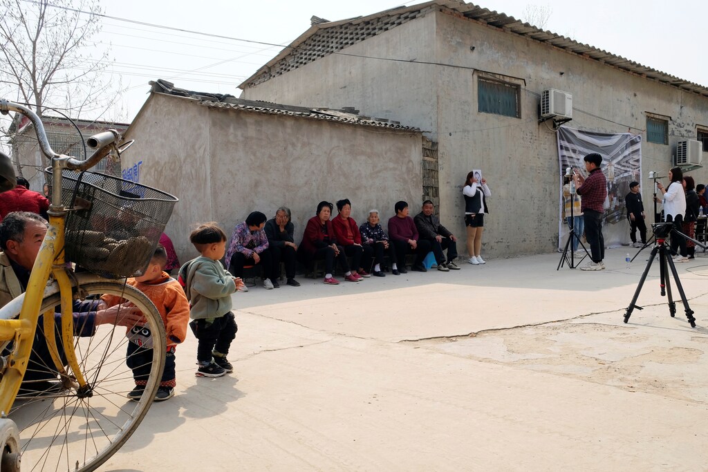 Workers from a Chinese data company take photos of the villagers for a facial recognition project.