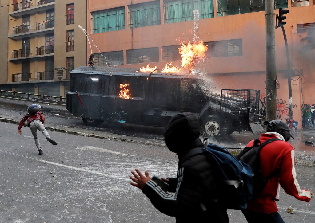 A police vehicle burns during a protest against Ecuador's President Lenin Moreno's austerity measures in Quito, Ecuador, 7 October 2019.