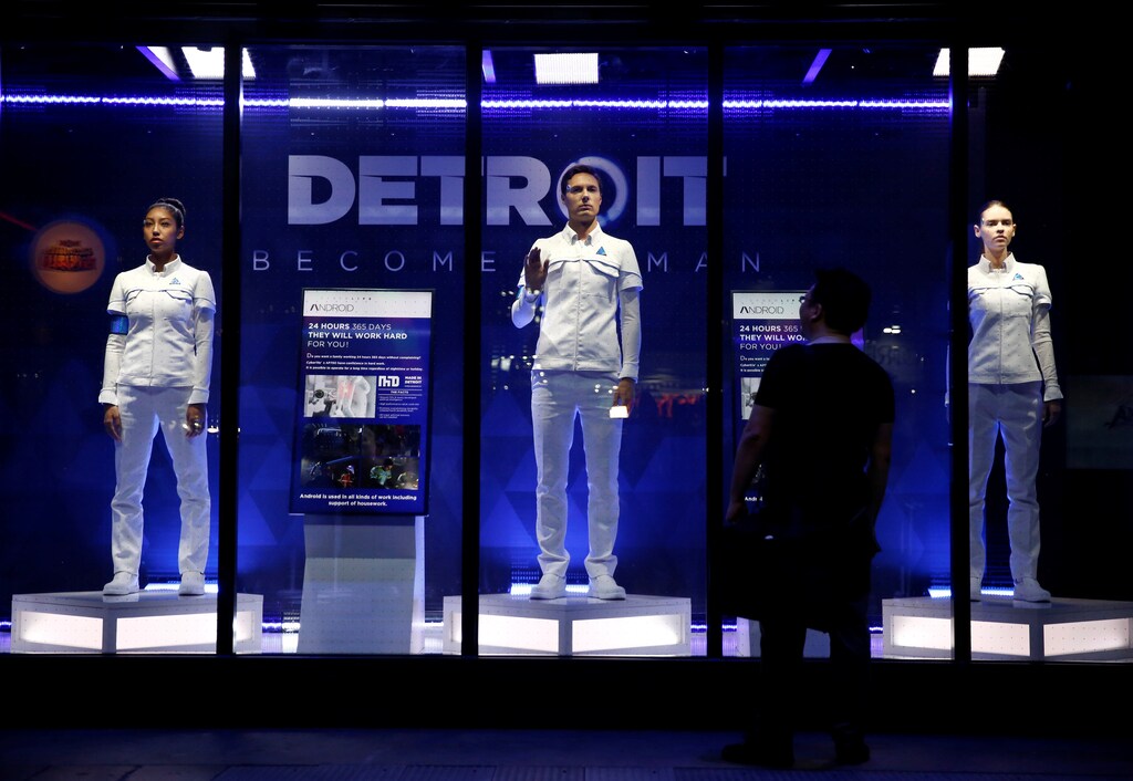 A man looks at models of android robots, game characters from "Detroit: Become Human" at Tokyo Game Show 2017 in Chiba, east of Tokyo, Japan, September 21, 2017. REUTERS/Kim Kyung-Hoon - RC198D7E9EA0