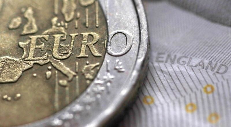 A two Euro coin is pictured next to an English ten Pound note in an illustration taken March 16, 2016. REUTERS/Phil Noble/Illustration - RTS12V91