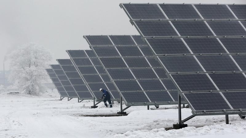 Dmitry Baikalov, a duty engineer, inspects equipment at the Abakan solar electric station in a suburb of the Siberian town of Abakan, Khakassia Republic, Russia, December 17, 2015. Owned by EuroSibenergo company of the En+ Group, the solar electric plant in Siberia with a generating capacity of 5.2 megawatt (MW) will be in operation on December 21, according to the official representative of the company. Picture taken December 17, 2015.