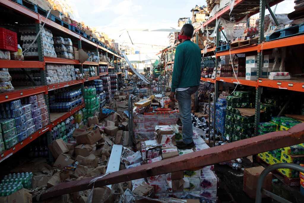 A man stands inside of a destroyed supermarket by Hurricane Maria in Salinas, Puerto Rico, September 29, 2017 REUTERS/Alvin Baez - RC1B29A80C60