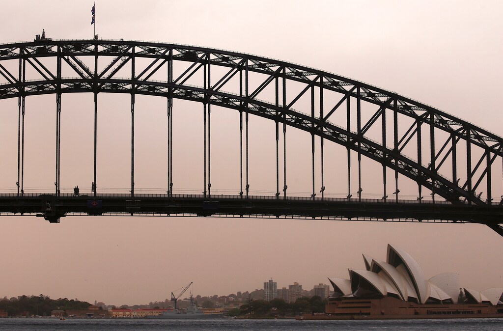 The Sydney Harbour Bridge and Sydney Opera House can be seen during a dust storm as it in descends upon the city of Sydney in Australia, November 22, 2018. REUTERS/David Gray - RC1252943BC0
