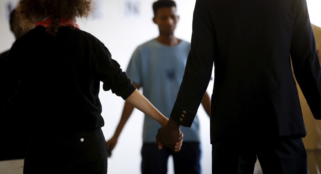Migrants and artists prepare to perform during the theater project 'Heart of Darkness', based on a novel by Polish novelist Joseph Conrad at a theater in Berlin, Germany, July 30, 2015.