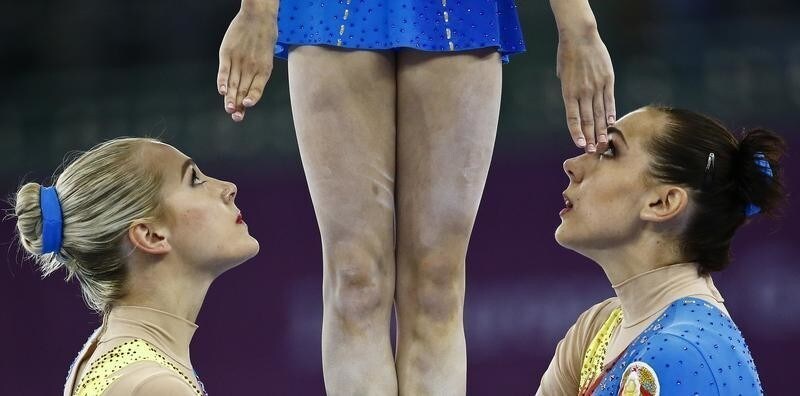 Katsiaryna Barysevich, Veranika Nabokina and Karina Sandovich of Belarus compete during the acrobatic gymnastics group qualification at the 1st European Games in Baku, Azerbaijan, June 17 , 2015.