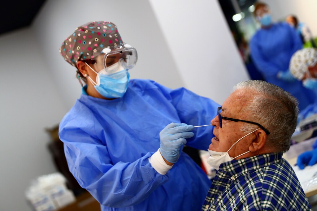 A man has a swab sample taken for a coronavirus disease (COVID-19) antigen test in the working-class neighbourhood of Vallecas which has been under partial lockdown, at a cultural centre in Madrid, September 29, 2020. REUTERS/Sergio Perez - RC2B8J9N4WW3